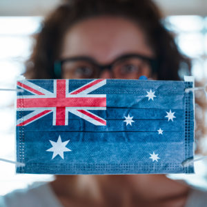 Pandemic Coronavirus. Close Up Of Young Woman With Surgical Mask With The Flag Of Australia On It