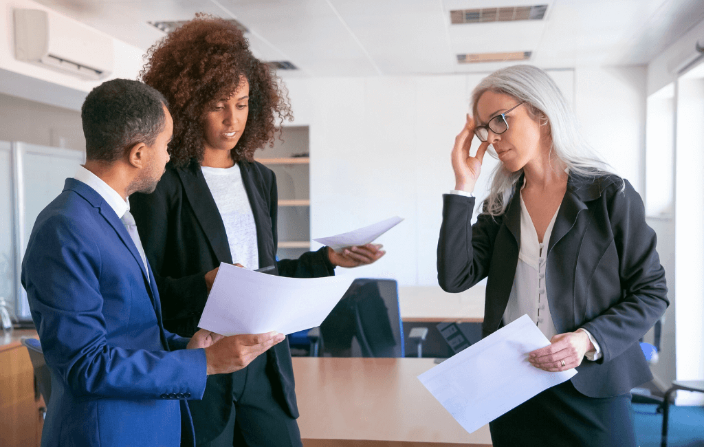 Company directors reviewing financial documents relating to tax compliance in Australia.