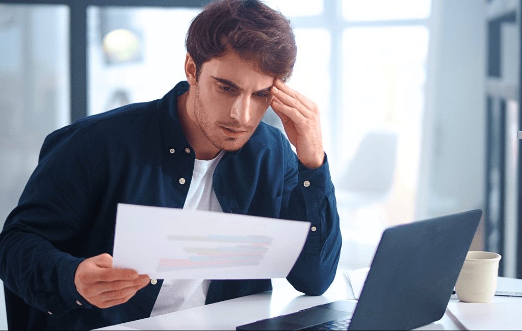 Business owner reviewing financial documents at desk to assess tax obligations in Australia