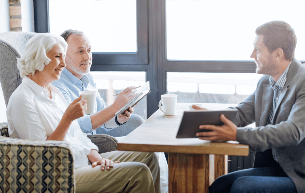 Retired couple meeting with a financial adviser to discuss SMSF aged care means testing and retirement planning.